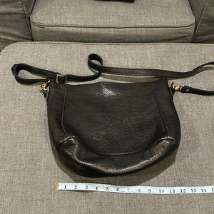 Portland Leather butterfly bucket bag with adjustable shoulder strap.